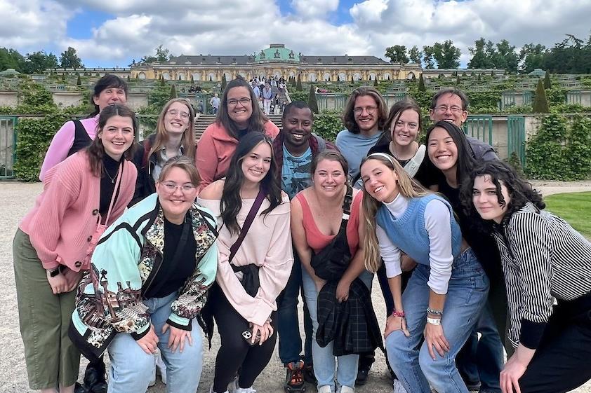 Students posing in front of a palace